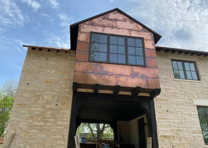 Copper metal panel facade on a stone building for Skylight Installation in Duxbury